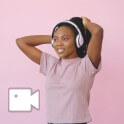 a girl in a pink shirt and headphones 