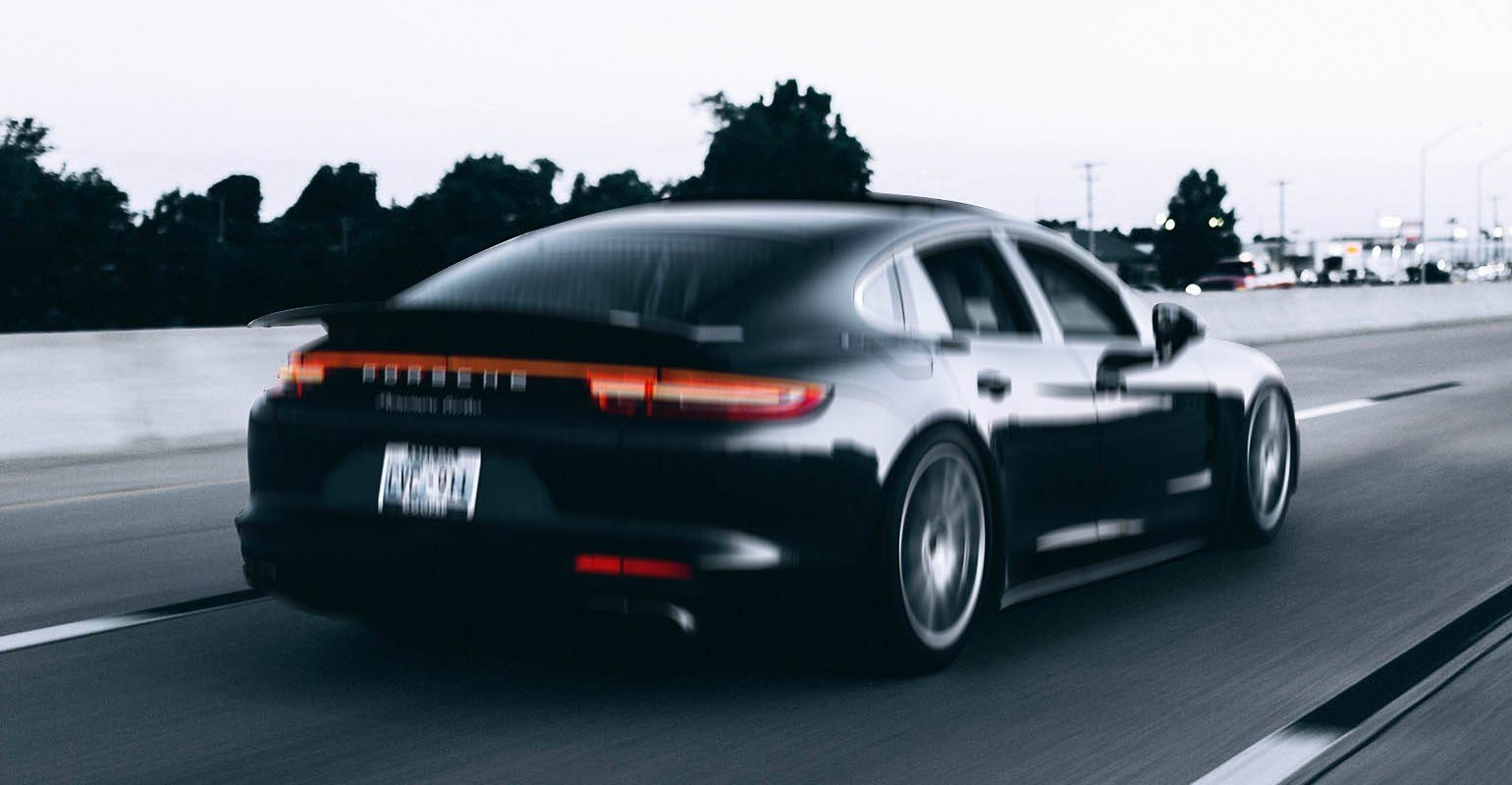 A blurry photo of a running black car